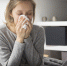Sick woman sitting in bed, blowing nose with napkin - ИА Общественная служба новостей