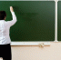 Teacher writing on the blackboard - ИА Общественная служба новостей