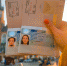 Female hands holding Ukrainian passports with Shengen visas on the Krakow city center background - ИА Общественная служба новостей
