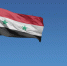 Flag of Syria in front of a clear blue sky - ИА Общественная служба новостей
