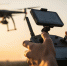 drone operator piloting flying drone sunset scaled - Государственный университет управления